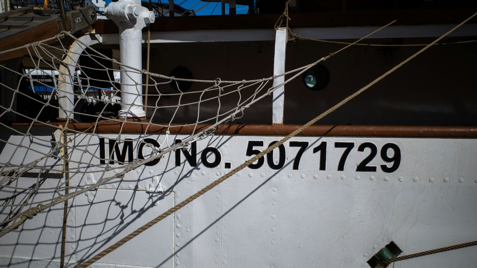 A close-up of painted identification markings on a ship's steel hull
