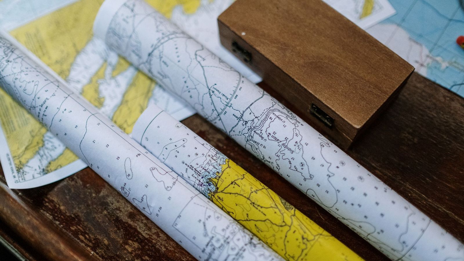 Nautical chart dividers and a parallel rule laid on a paper chart