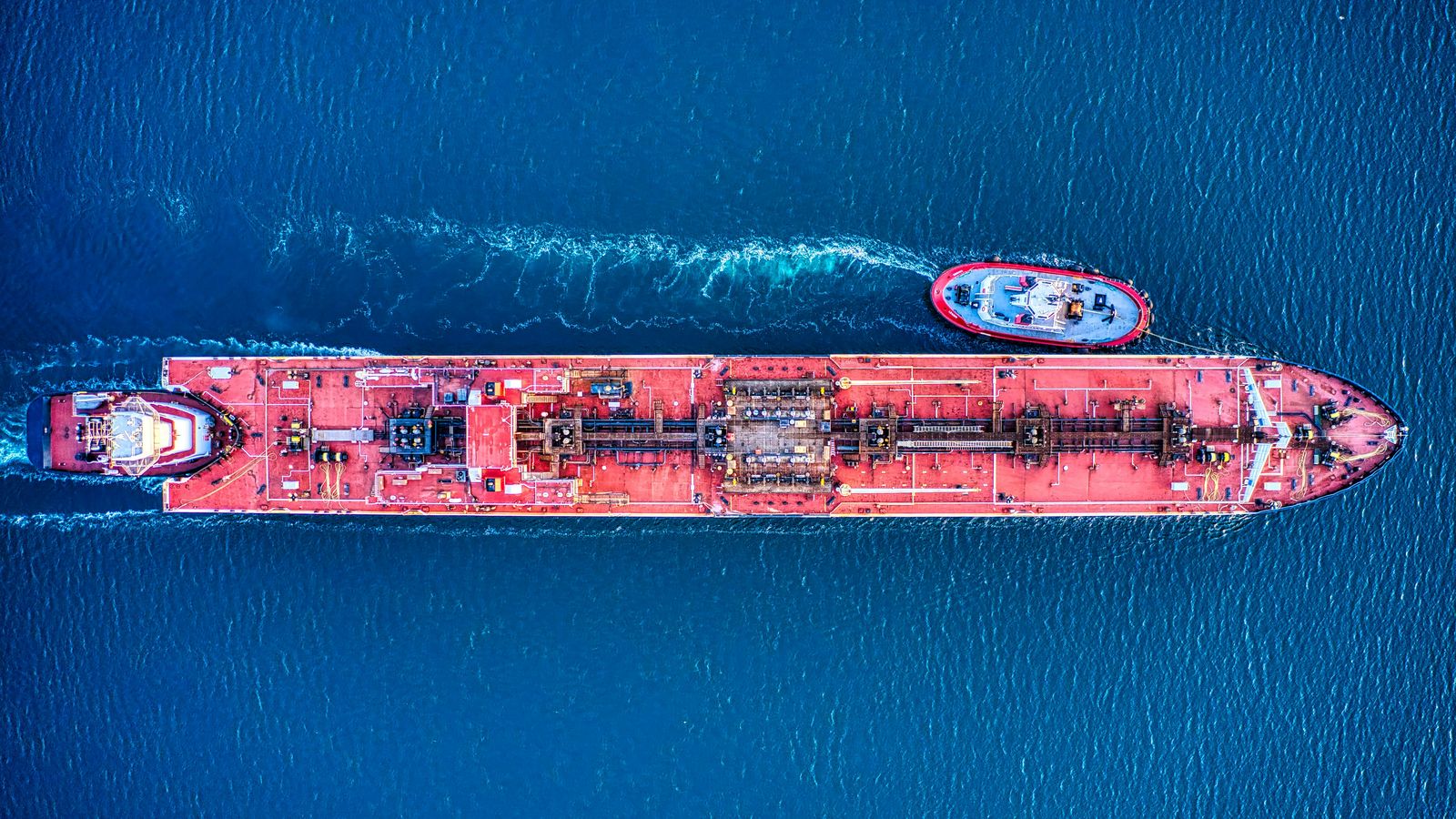 An aerial view of a working harbour with vessels alongside